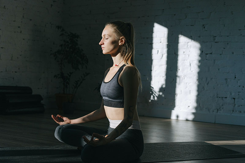 self-aware woman meditating